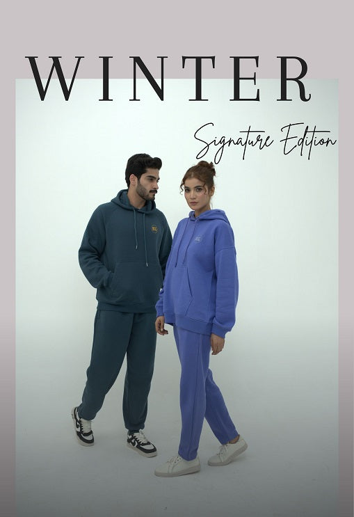 Two people wearing matching blue and green winter outfits with 'Winter Signature Edition' text.