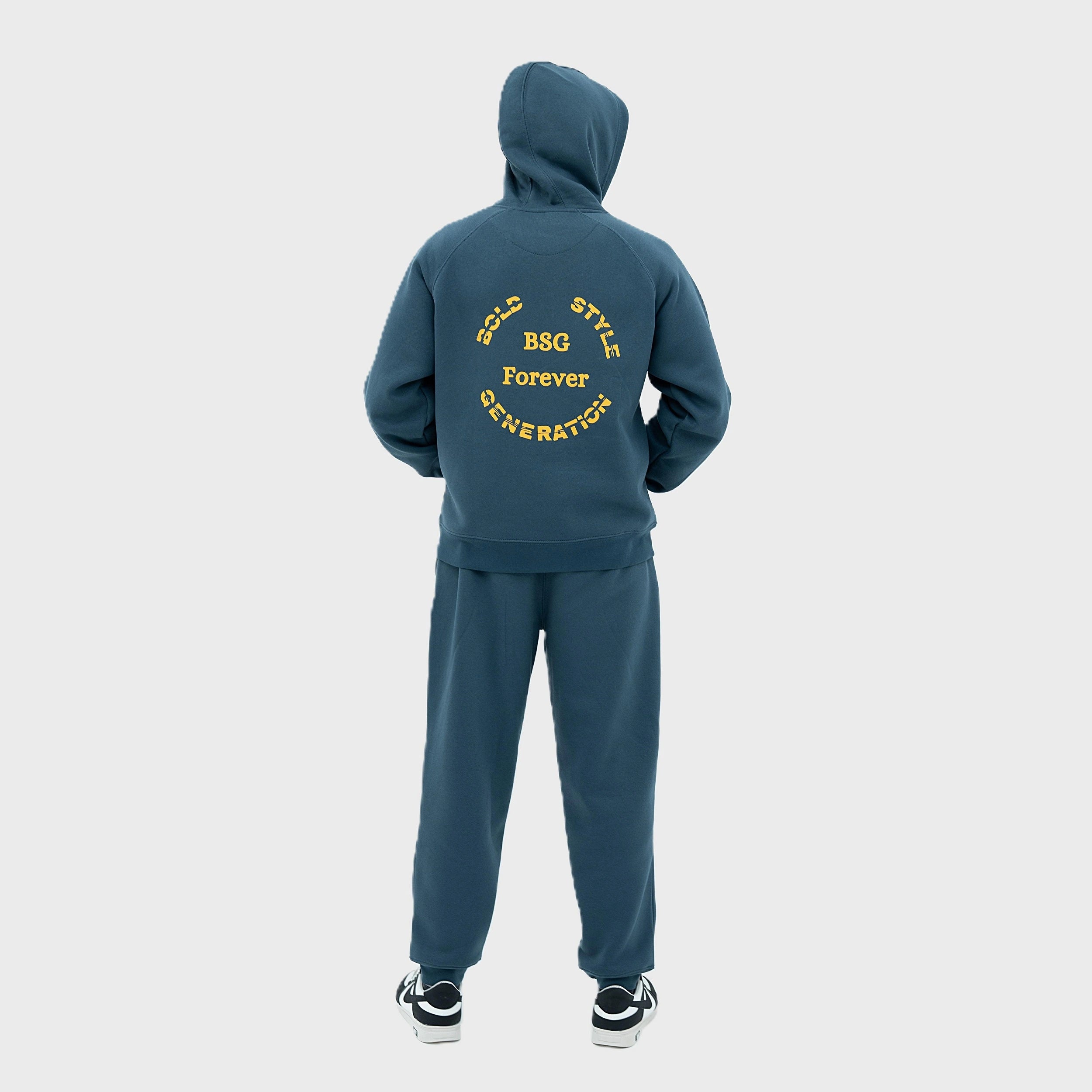 Teal tracksuit with yellow text on the back against a white background