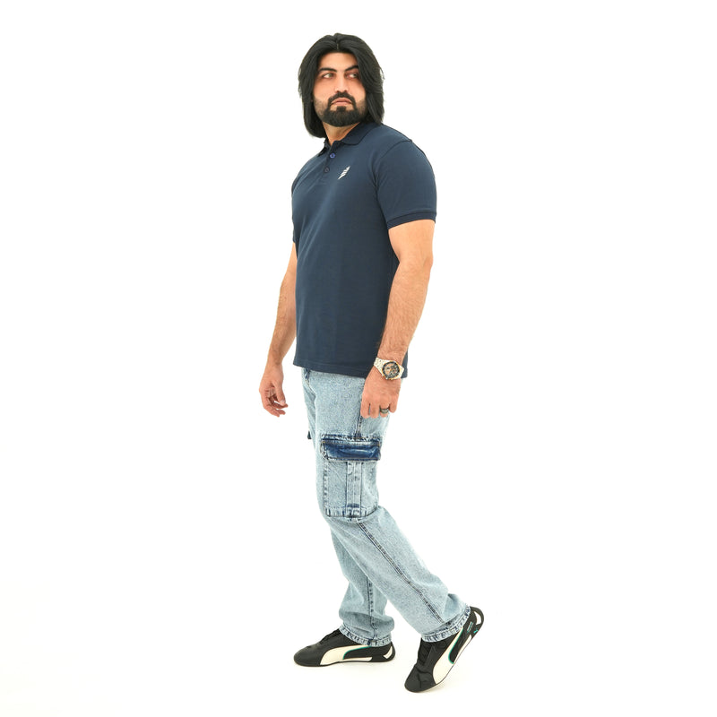 Man wearing BSG navy polo shirt and light blue jeans on a white background