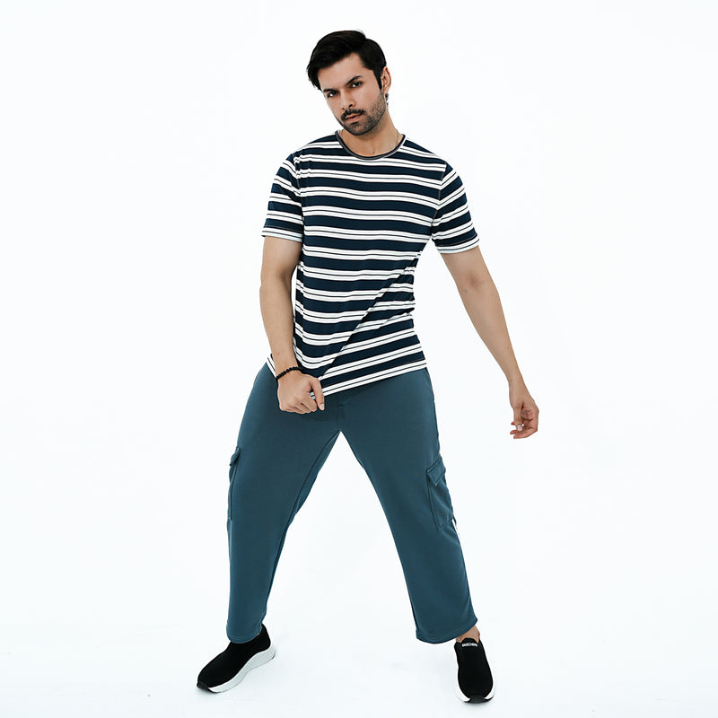 Man wearing a striped shirt and blue pants on a white background