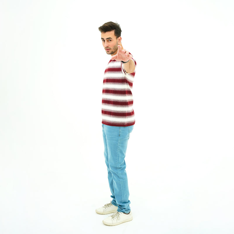 Man wearing BSG striped tank top and jeans pointing forward on a white background