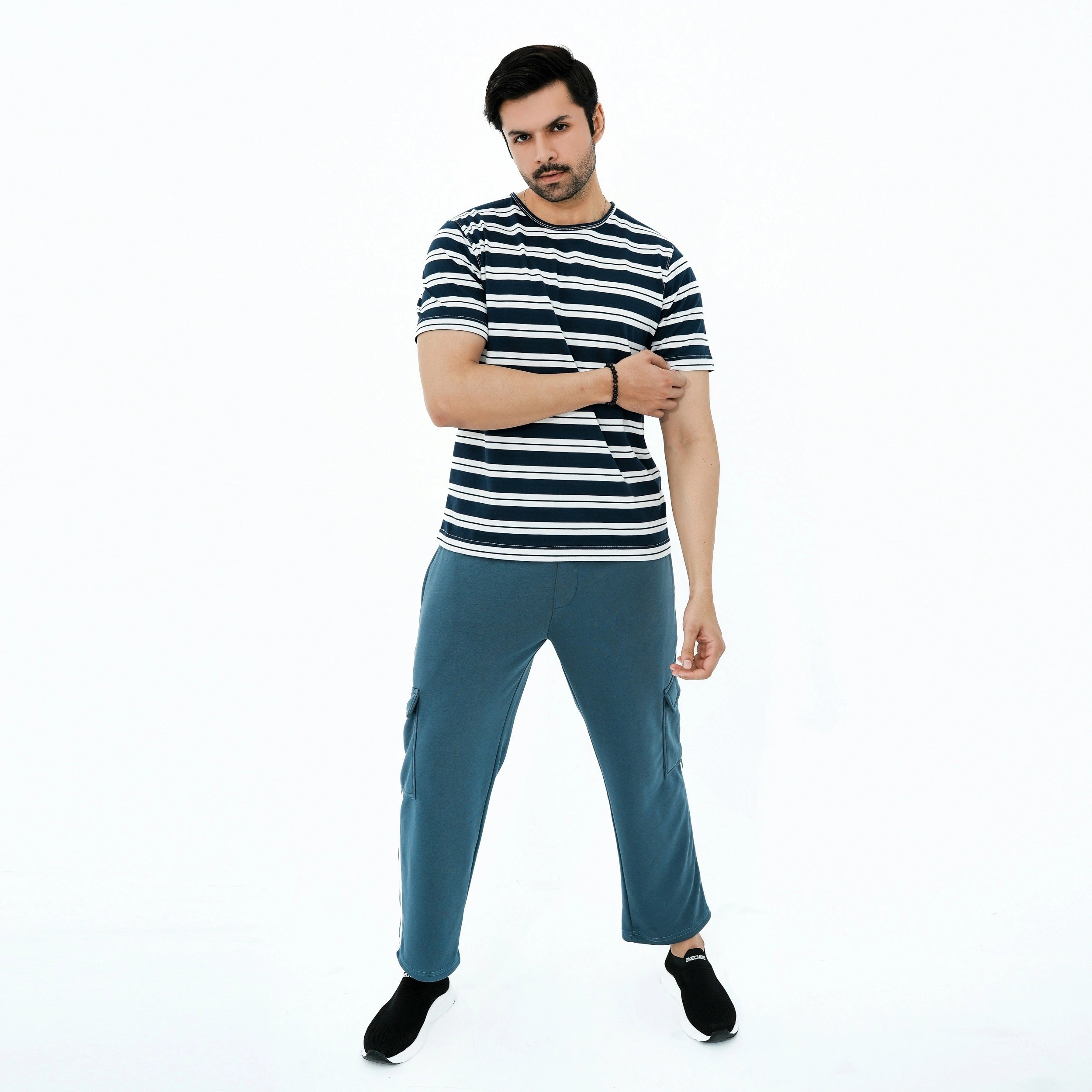Man wearing a striped shirt and blue pants on a white background