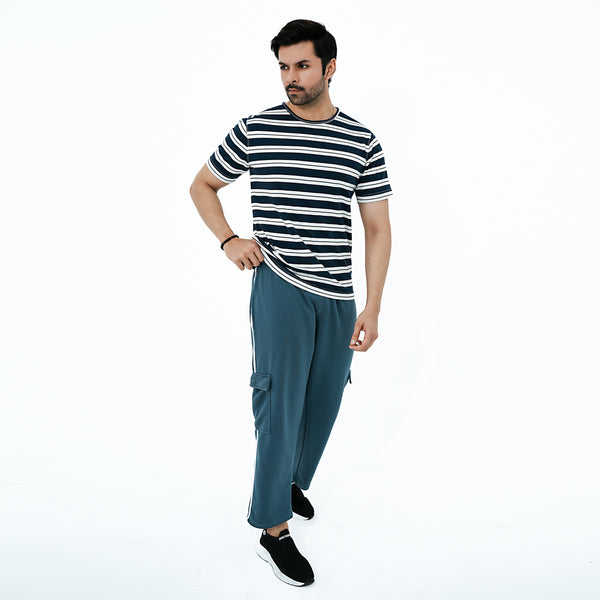 Man wearing a striped shirt and blue pants on a white background