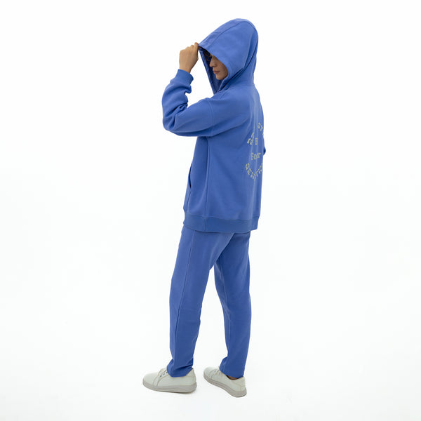 Person wearing a blue tracksuit on a white background
