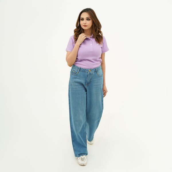 Woman wearing BSG purple polo shirt and blue jeans on a white background