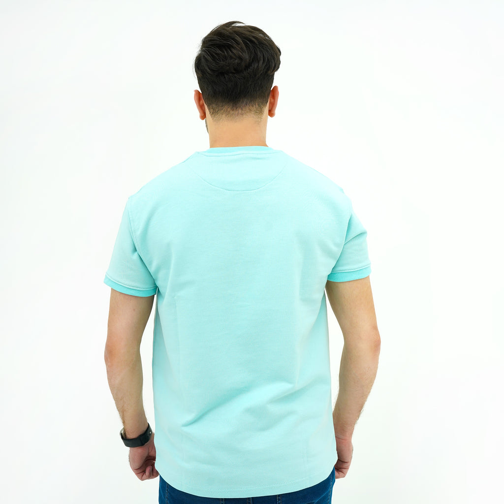 Back view of a man's Aqua Breeze Misty Wave Terry Tee Shirt in a light blue color