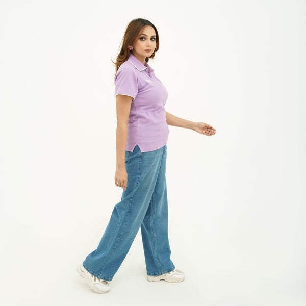 Woman wearing BSG Azure Sky Breeze Wide Leg Jeans with a lavender polo shirt and white sneakers