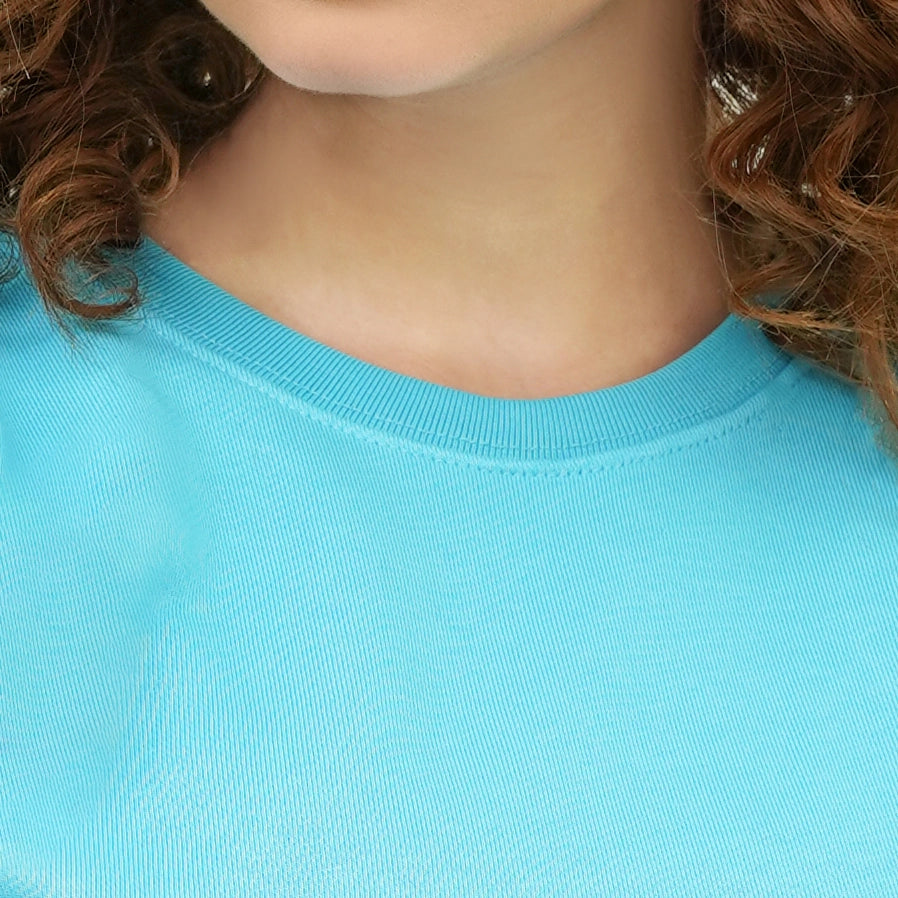 Close-up of a woman wearing the Boldly Born Blue Brilliance Tee Shirt in vibrant blue fabric