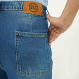 Close-up of BSG women's Breezy Blue Flapped Jeans showing back pocket and leather brand patch
