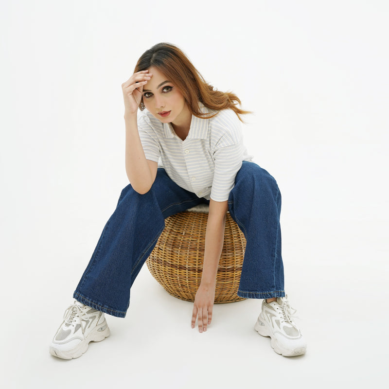 Woman wearing BSG Indigo Blue Wide Leg Jeans paired with white sneakers and a striped shirt