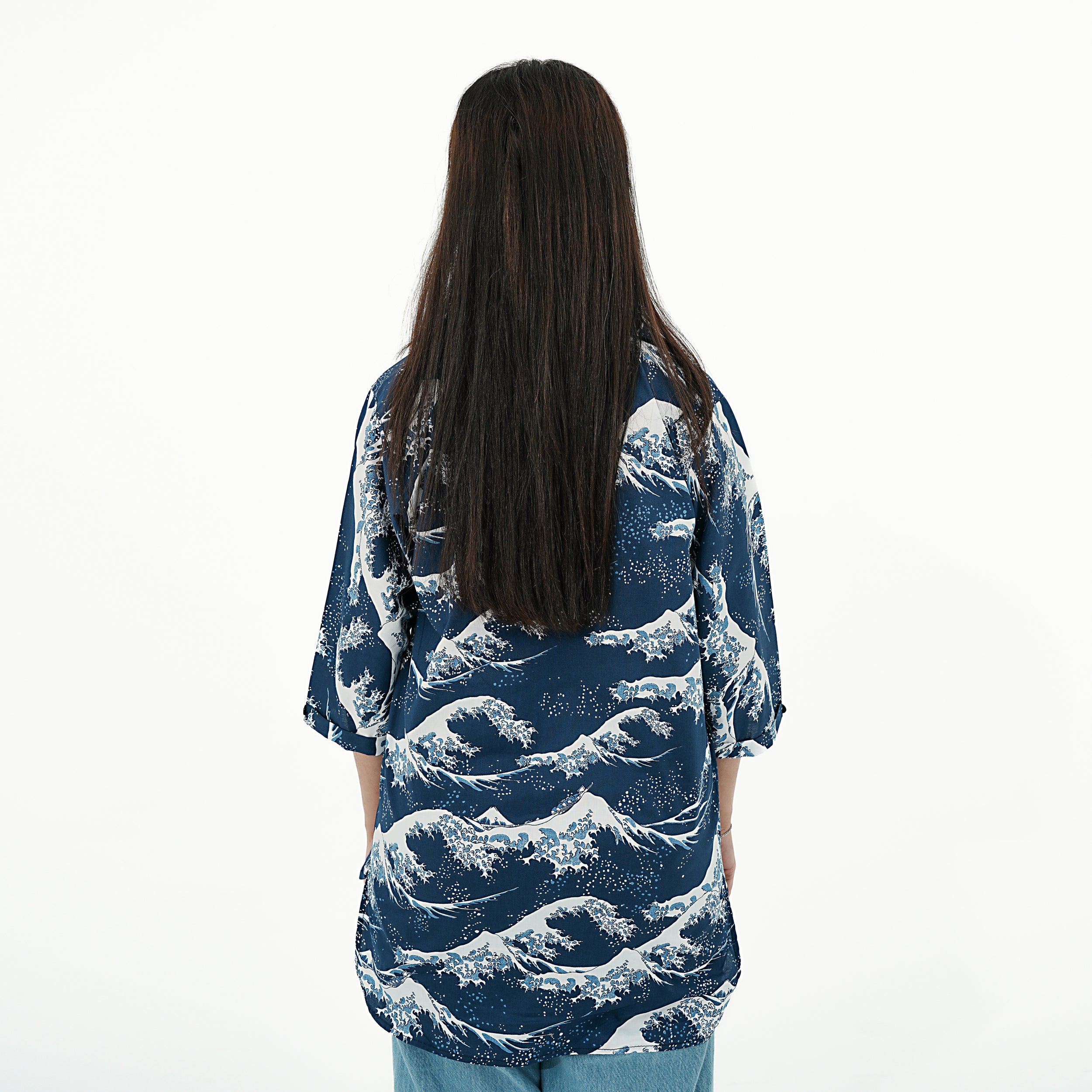 Back view of the Coastal Breeze Button-Up Shirt for women featuring a wave pattern and relaxed fit