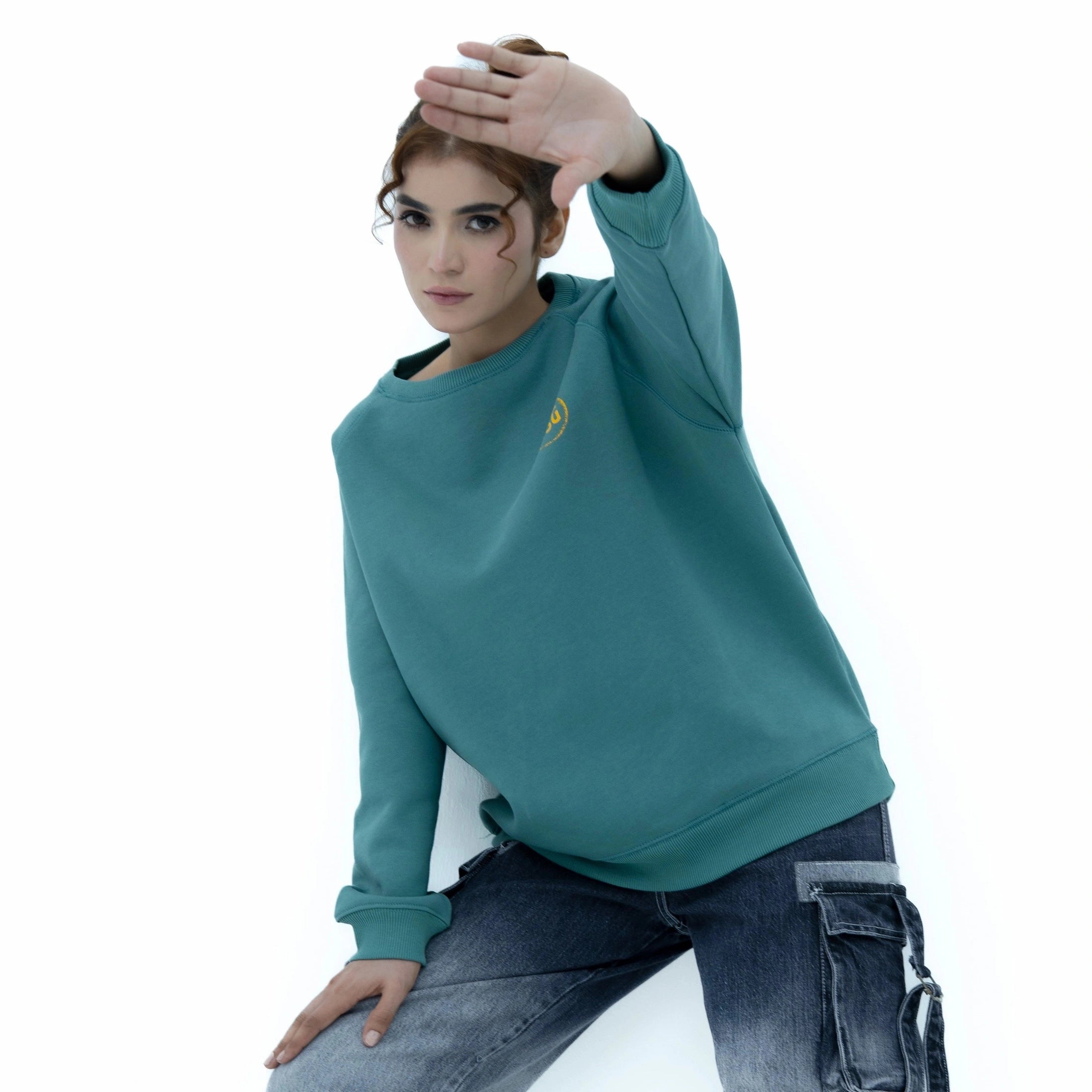 BSG Culture Vibe Green Harmony Sweatshirt modeled by a woman in casual jeans