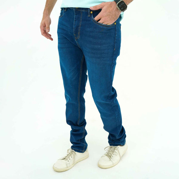 Men's BSG Deep Indigo Slim-Fit Jeans styled with white sneakers and casual pose