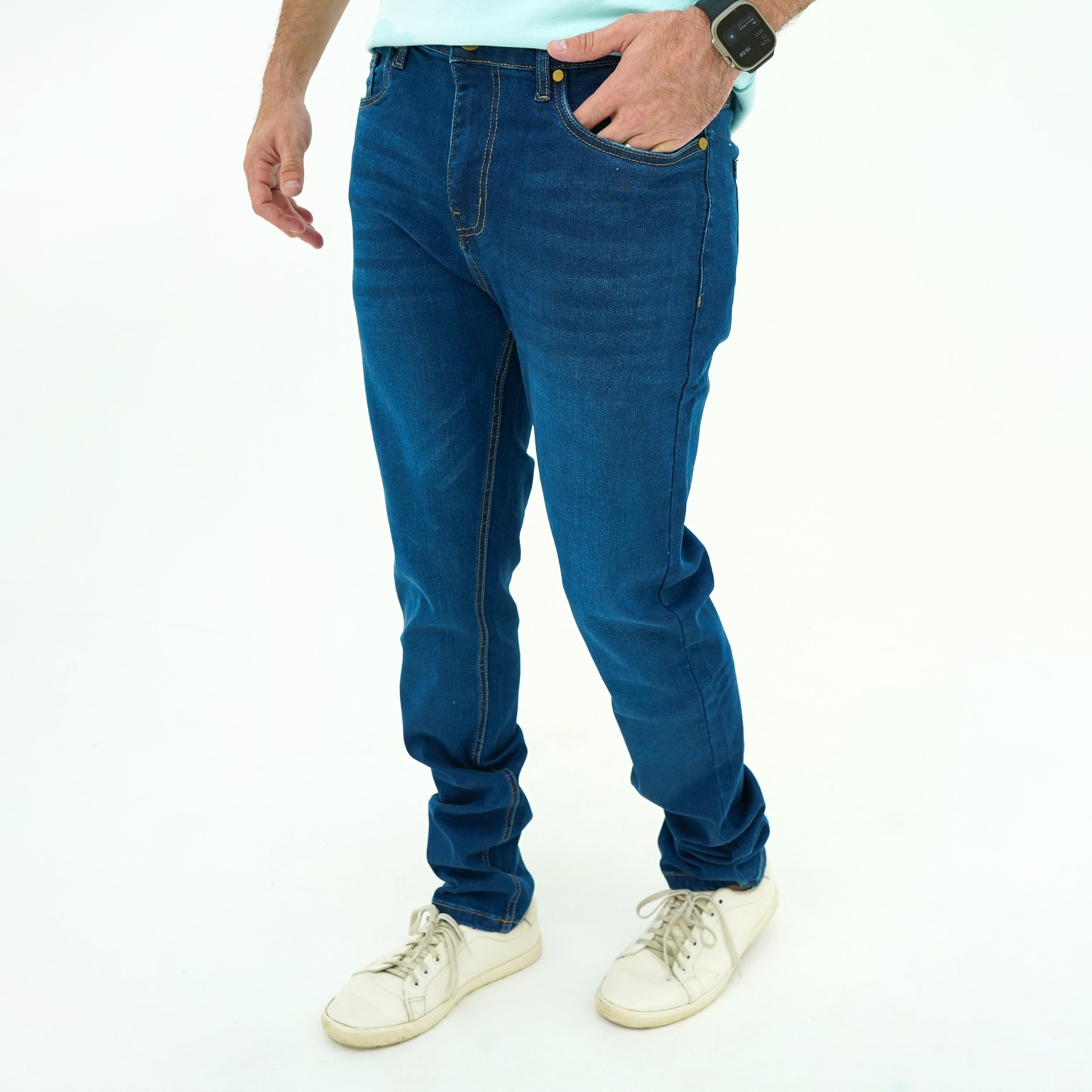 Model wearing Deep Indigo Slim-Fit Jeans paired with casual sneakers for a stylish look