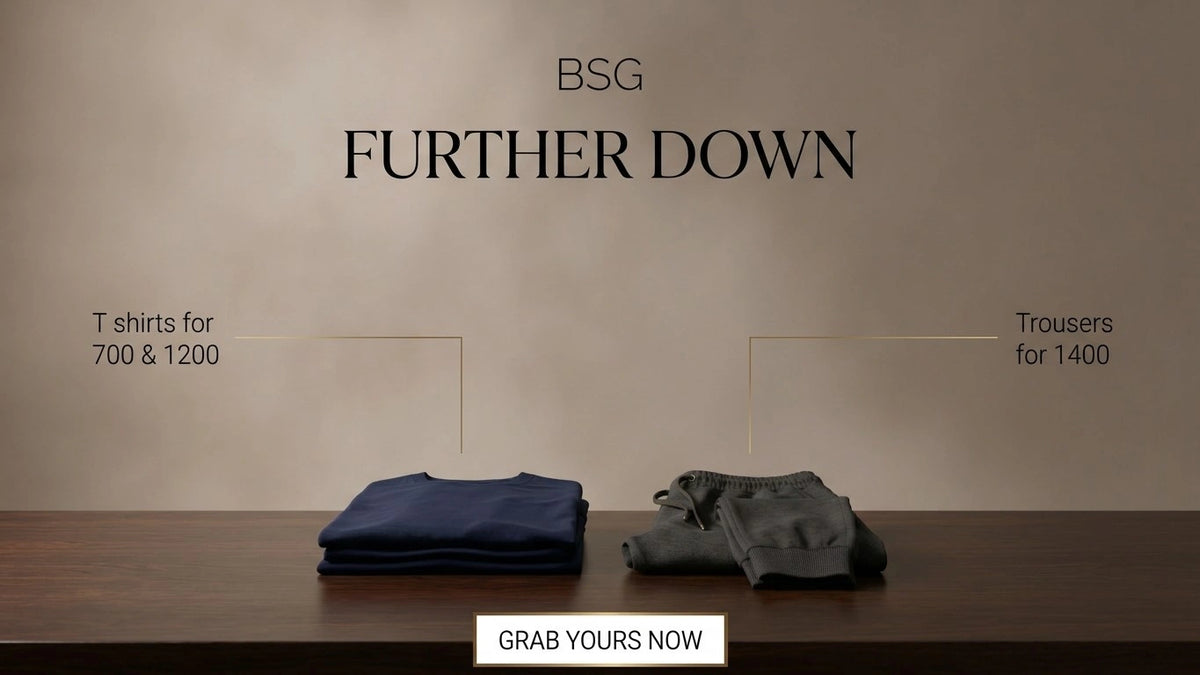Promotional banner for BSG 'Further Down' featuring folded navy blue and gray trousers on a wooden table against a textured beige wall, with text indicating T-shirts for 700 & 1200 and trousers for 1400, and a 'Grab Yours Now' button at the bottom.