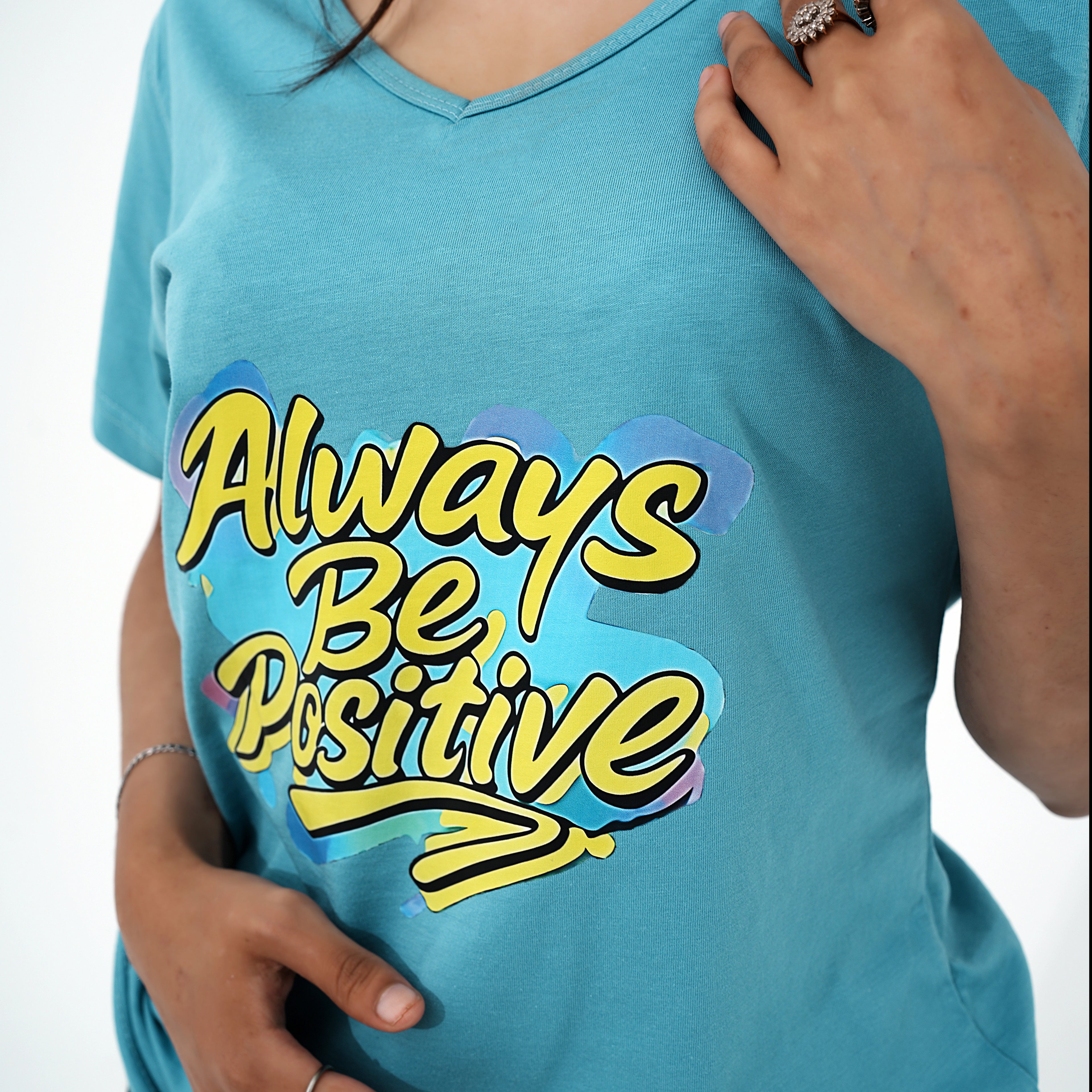 BSG positivity v-neck shirt in blue with vibrant 'Always Be Positive' graphic design