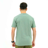 Back view of man wearing Verdant Charm Pistachio Luxe Tee Shirt by BSG in light green color