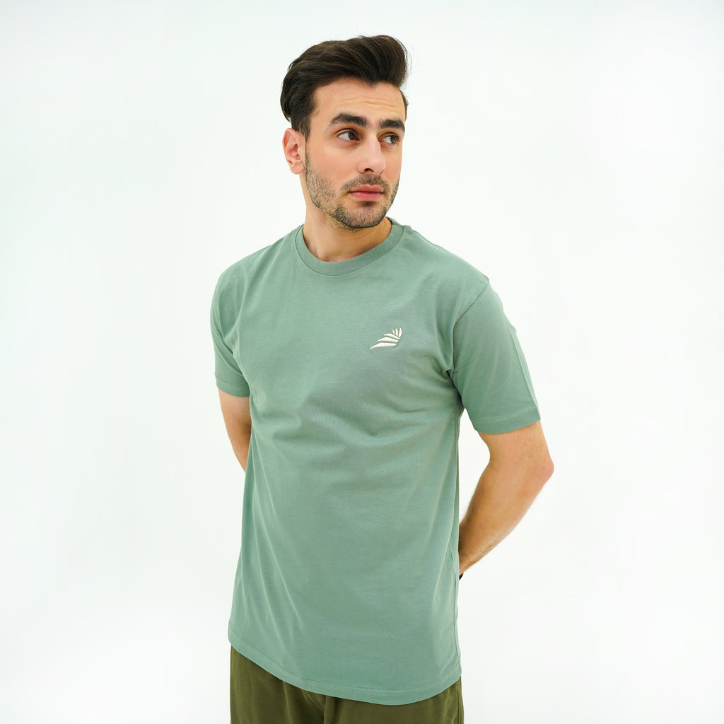 Men's Verdant Charm Pistachio Luxe Tee Shirt from BSG, featuring a comfortable fit and stylish design